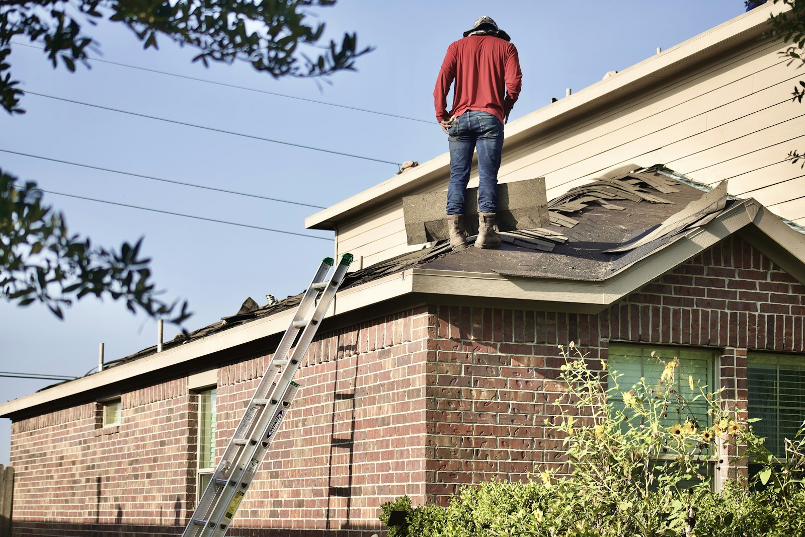 Roofer inspecting a residential roof.
